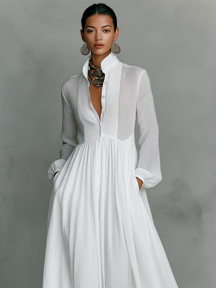 Close-up of pintuck detail & button front on a women's elegant pleated long sleeve maxi dress for everyday wear.
