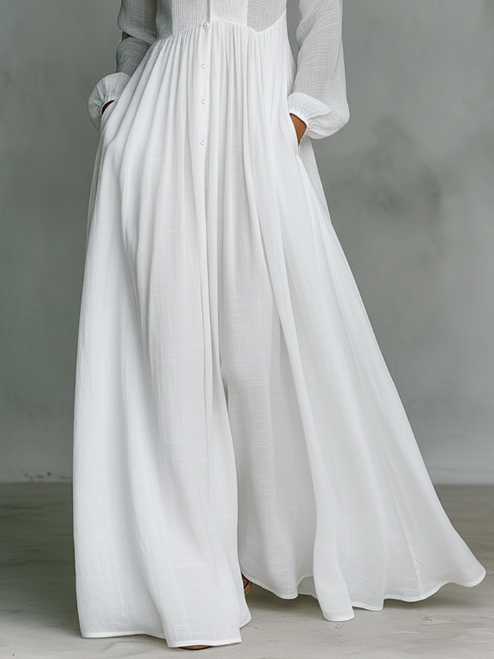 Full-length view of women's casual pleated maxi dress. Button front, pintuck detail, long sleeves, stand-up collar.