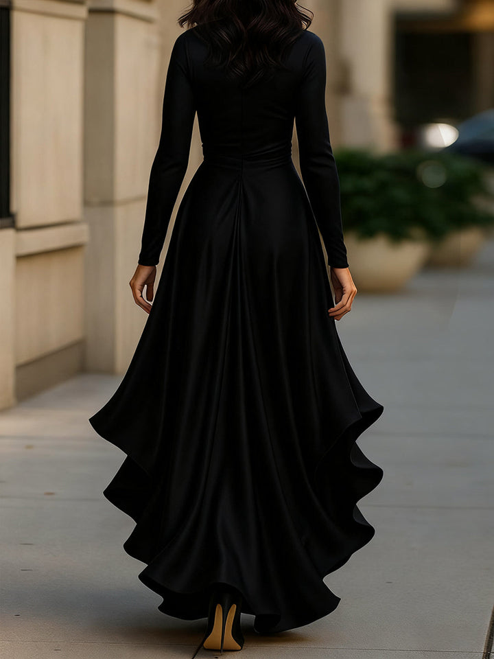 Back view of a women's elegant pleated maxi dress in a jewel tone, perfect for a wedding guest or formal event.