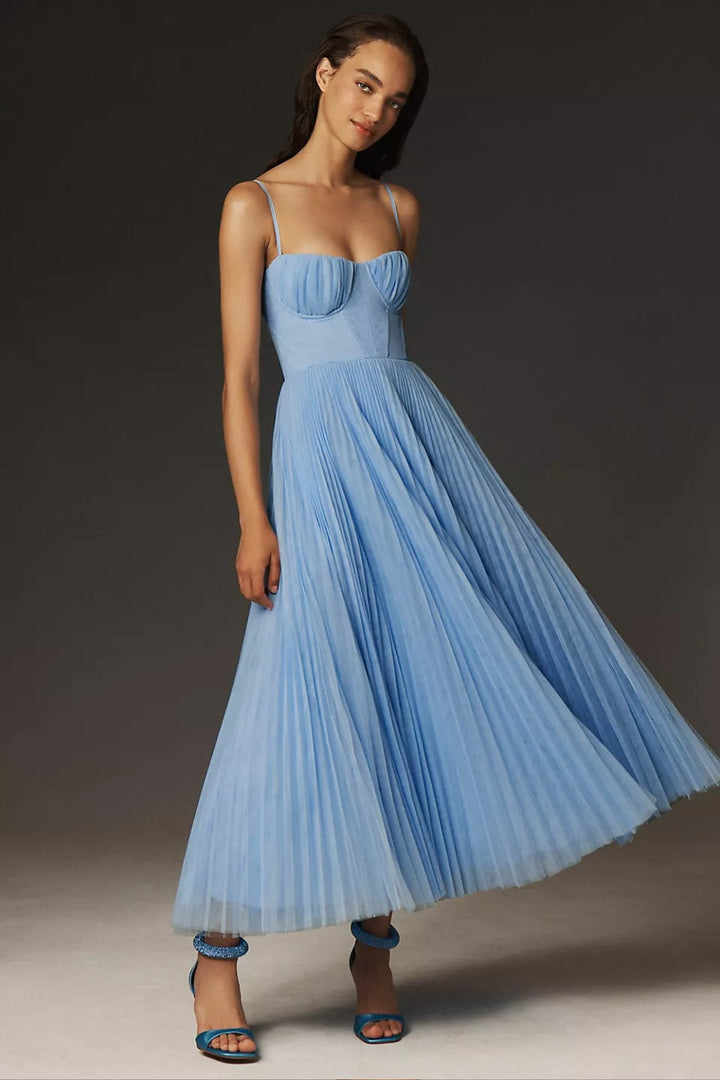 Green pleated tulle midi slip dress. Features a stylish corset bodice & delicate spaghetti straps for evenings.