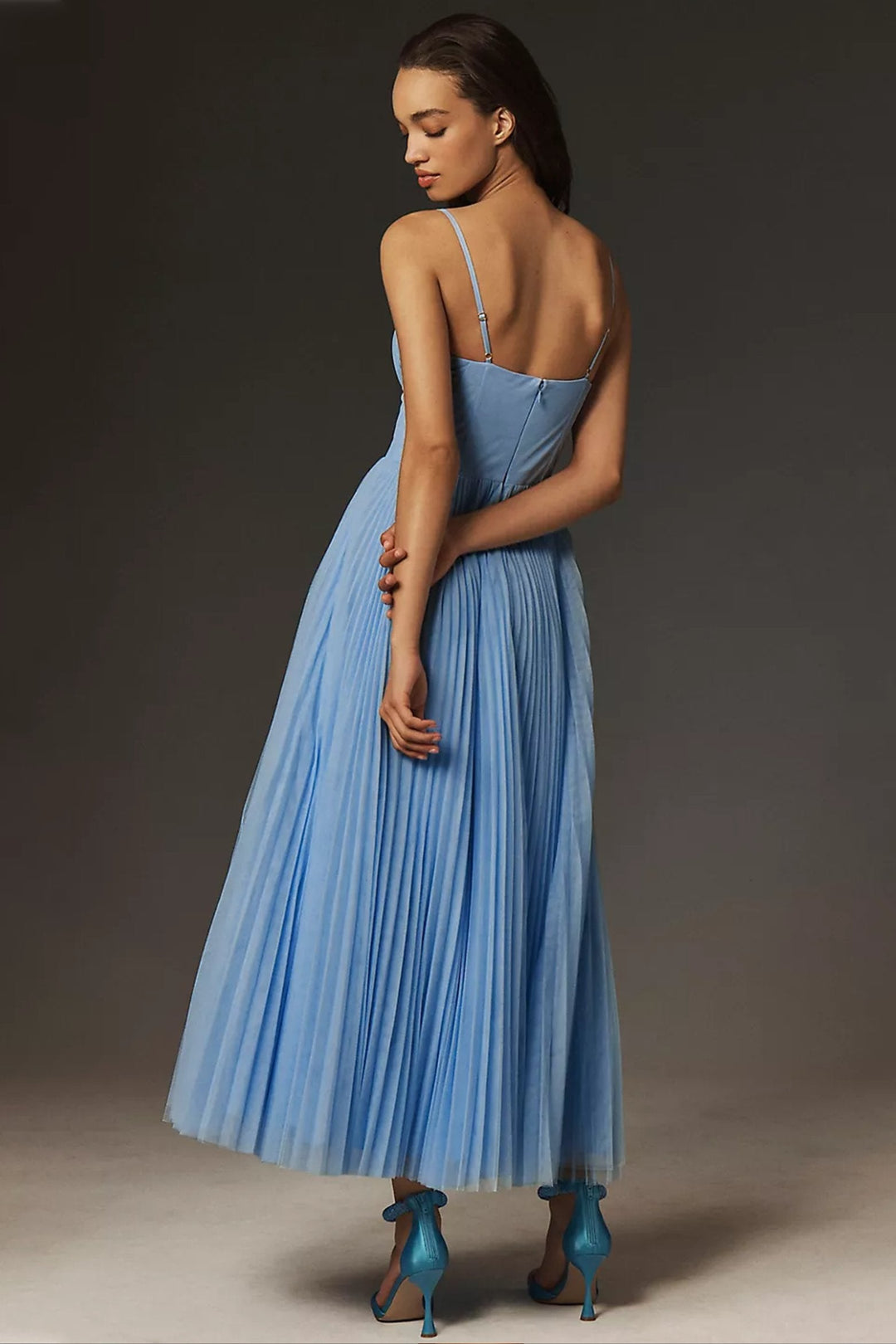 Chic orange pleated tulle slip dress. Corset bodice, midi length & spaghetti straps make it ideal for parties.