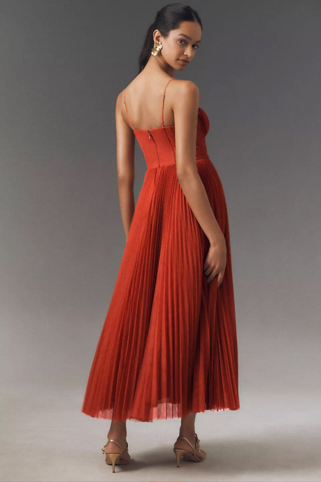 Women's midi slip dress featuring a corset-style bodice & flowing pleated tulle skirt. Great for occasions.