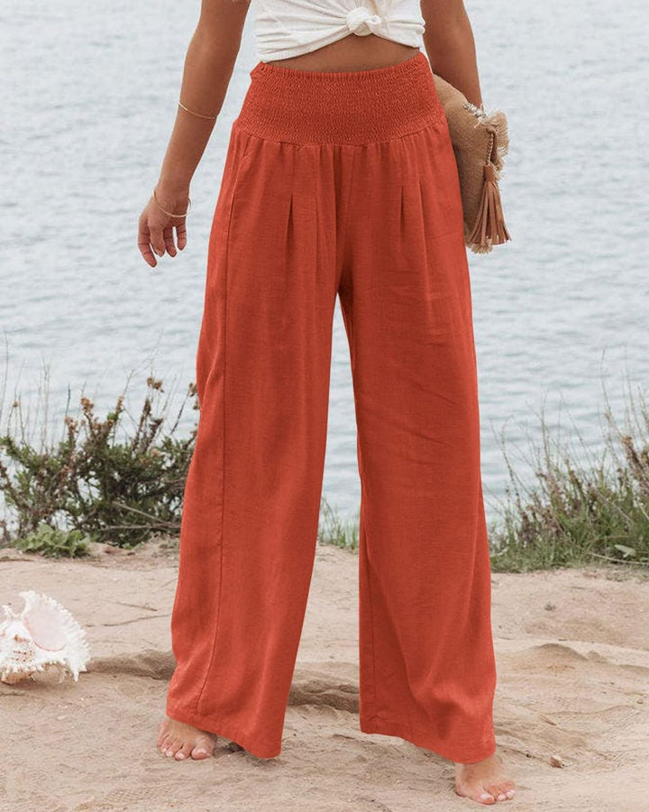 Flowy women's wide leg pants with pleats & elastic waist, perfect for casual summer wear.