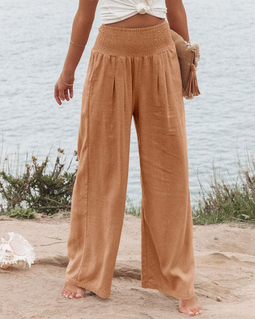 Stylish women's pleated trousers, wide leg design, elastic waist for ultimate comfort & fashion.