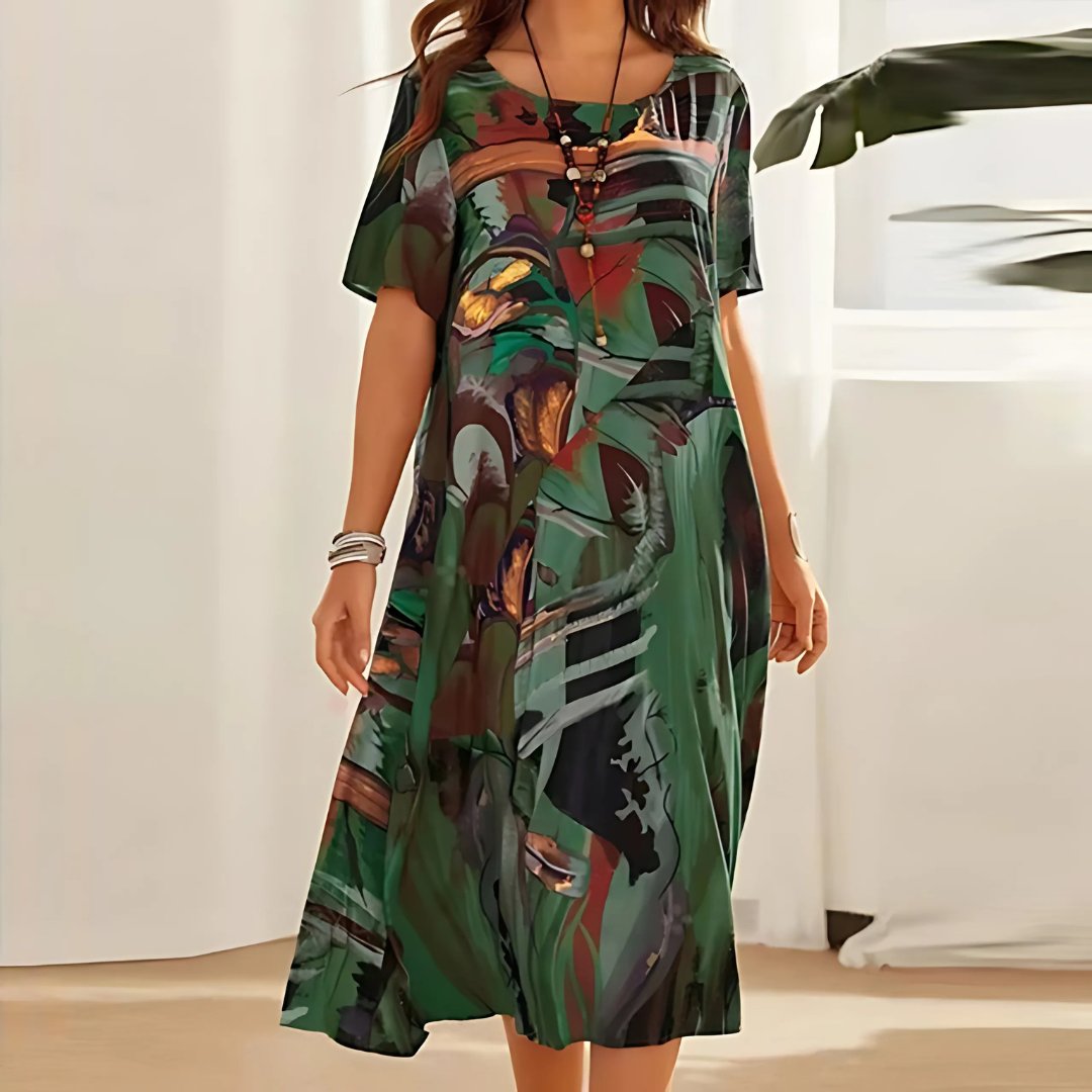 Vibrant abstract print plus size midi dress for women. Relaxed short sleeve, perfect for comfortable summer fashion.