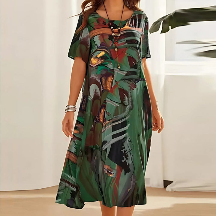 Vibrant abstract print plus size midi dress for women. Relaxed short sleeve, perfect for comfortable summer fashion.