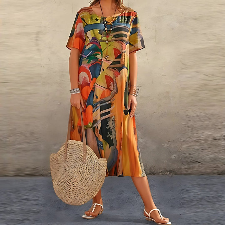 Stylish women's plus size short sleeve midi dress. Features a vibrant abstract print & comfortable relaxed fit.