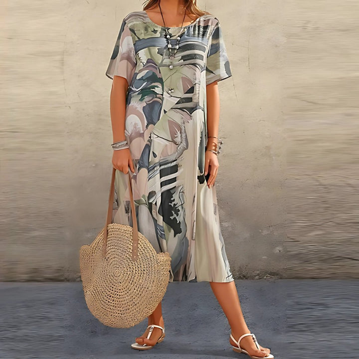 Comfortable women's plus size abstract print midi dress. Relaxed fit, short sleeves, ideal for casual summer days.
