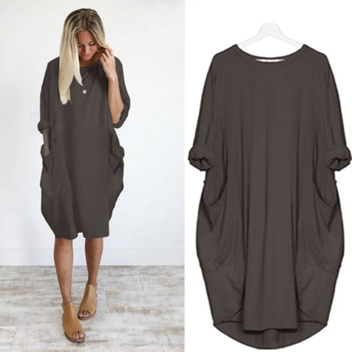 Elegant women's plus size black midi dress, featuring an oversized design, batwing sleeves, and side pockets.