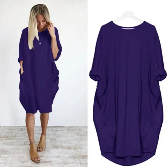 Chic plus size black pocket dress, midi length with dramatic batwing sleeves for a fashionable statement.