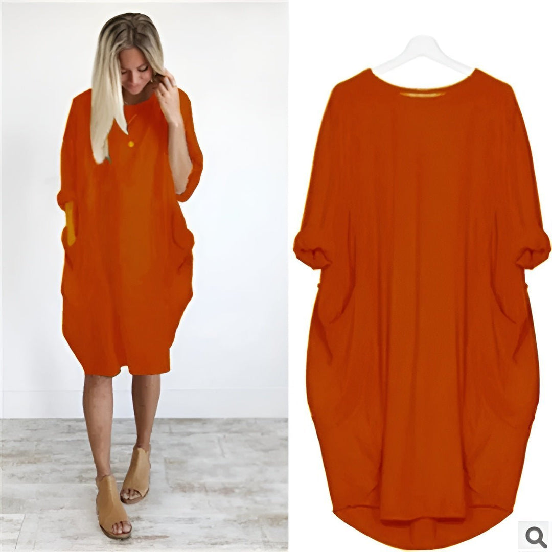Detail of pockets and batwing sleeves on a comfortable women's plus size black midi casual dress.