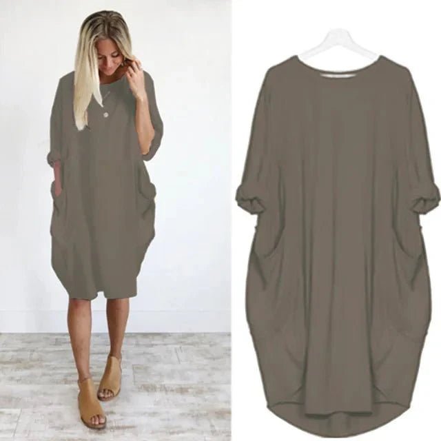 Versatile black midi dress for plus size women, with practical pockets and a comfortable batwing design.