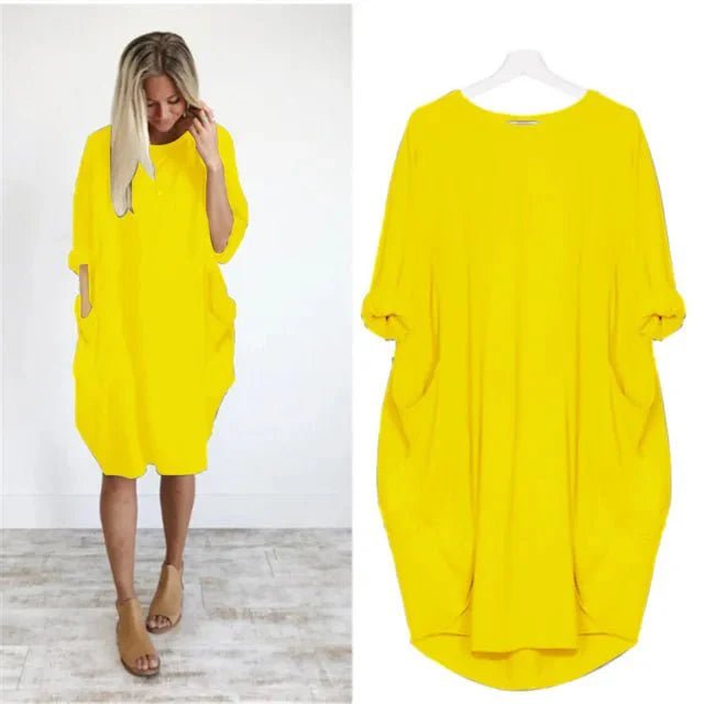 Side profile of a comfortable women's plus size batwing sleeve midi dress in black, perfect for any season.