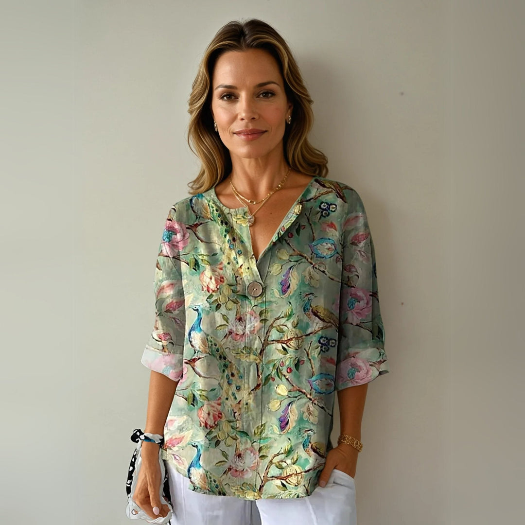 Women's plus size V-neck button-up blouse with vibrant floral print. Effortless long sleeve spring top.