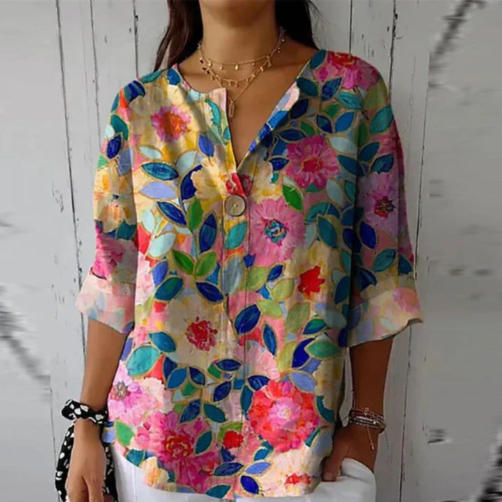 Elegant plus size V-neck floral blouse, button-up. Features a vibrant print and relaxed fit.