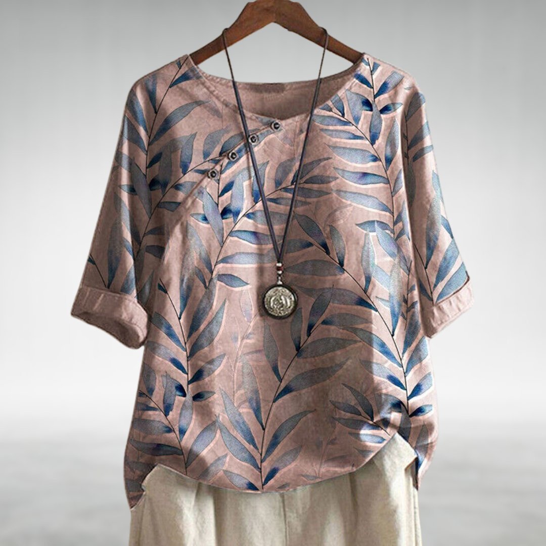 Elegant plus size blouse featuring a vibrant leaf print, relaxed fit & stylish three-quarter sleeves for women.