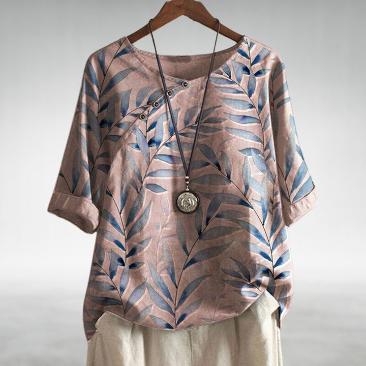 Elegant plus size blouse featuring a vibrant leaf print, relaxed fit & stylish three-quarter sleeves for women.