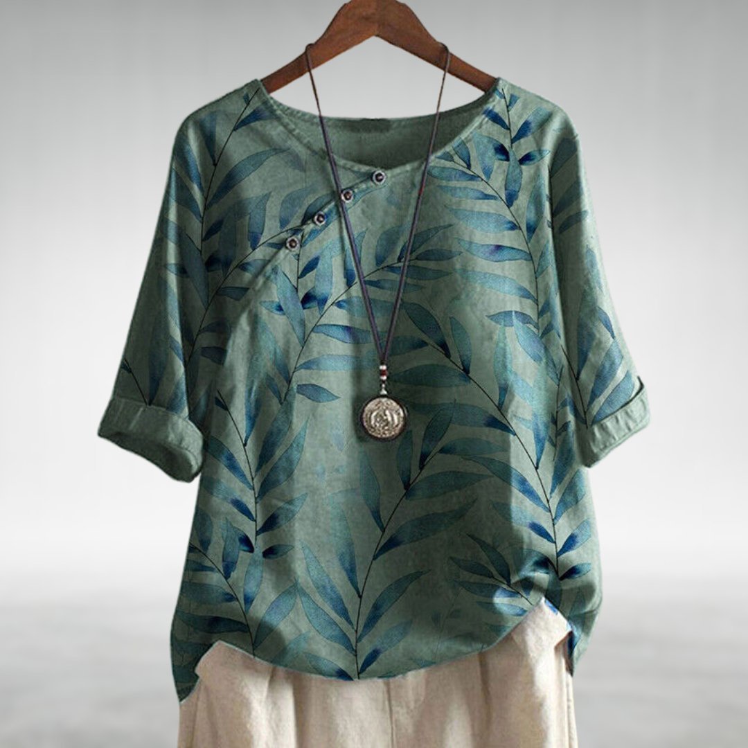 Front view of a women's plus size floral leaf print button-down blouse in a comfortable relaxed fit style.