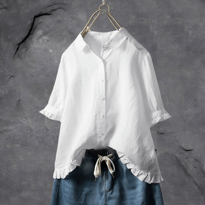 Chic plus size button-front top for women, featuring a ruffled collar & comfortable short sleeves. Casual to work style.