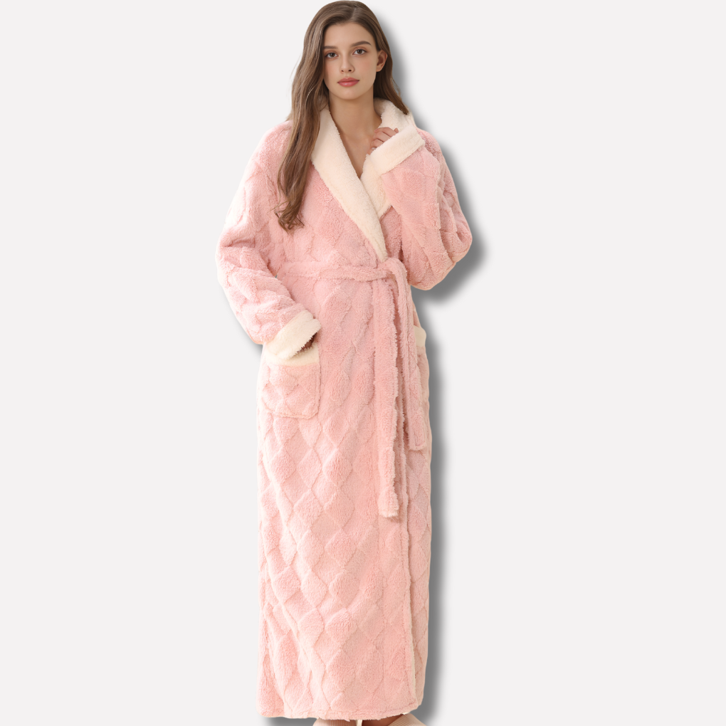Women's plush hooded flannel robe made of soft coral fleece. Ideal full-length loungewear for ultimate winter warmth.