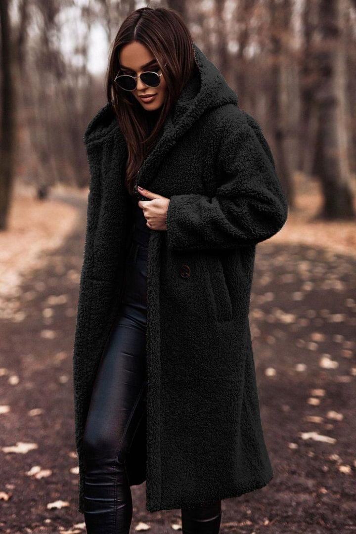 Cozy women's hooded teddy coat. Plush, stylish outerwear for winter comfort and warmth.