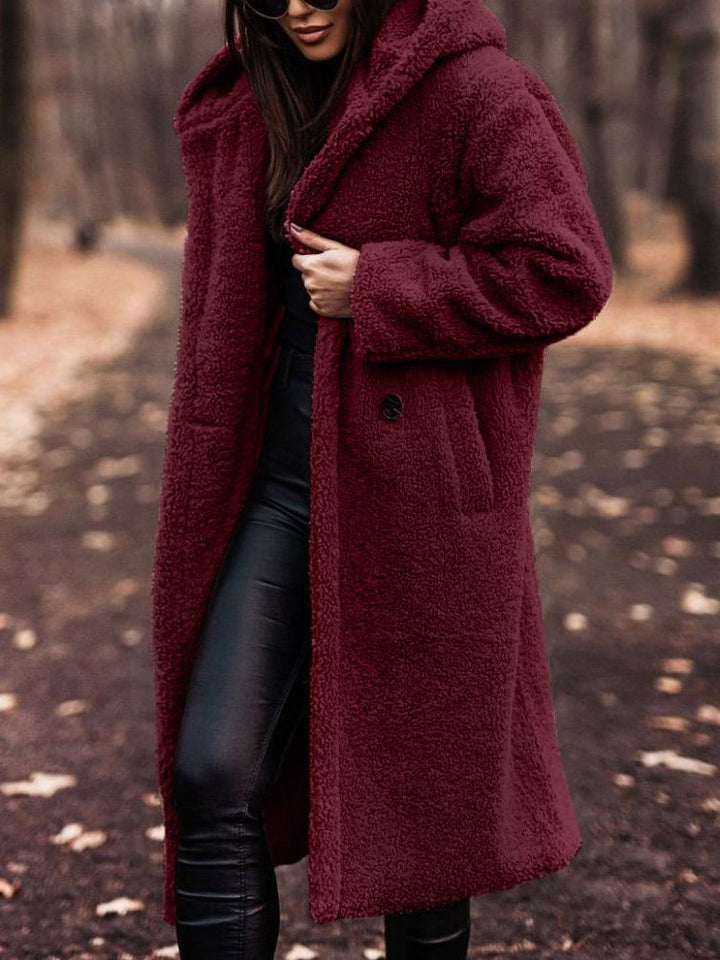 Fashionable women's plush hooded winter coat, an essential long jacket for cozy fall and winter outfits.