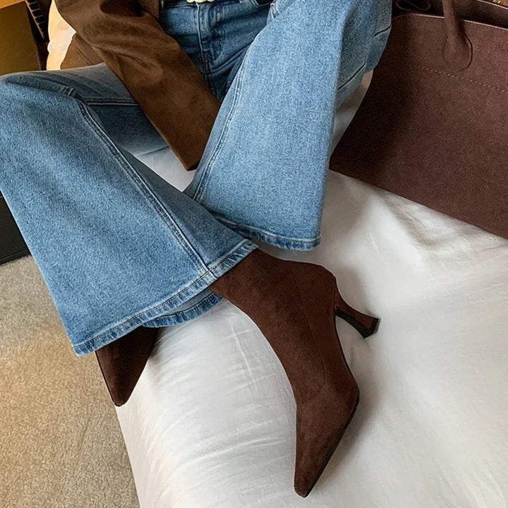 Stylish brown women's heeled ankle boots with pointed toe. Comfortable mid-heel for everyday and dress.
