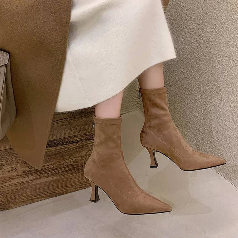 Sleek pointed toe heeled ankle boots for women, featuring a comfortable mid-heel. Ideal fashion footwear.