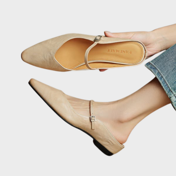 Women's pointed toe slip-on mule flats with elegant strap detail.