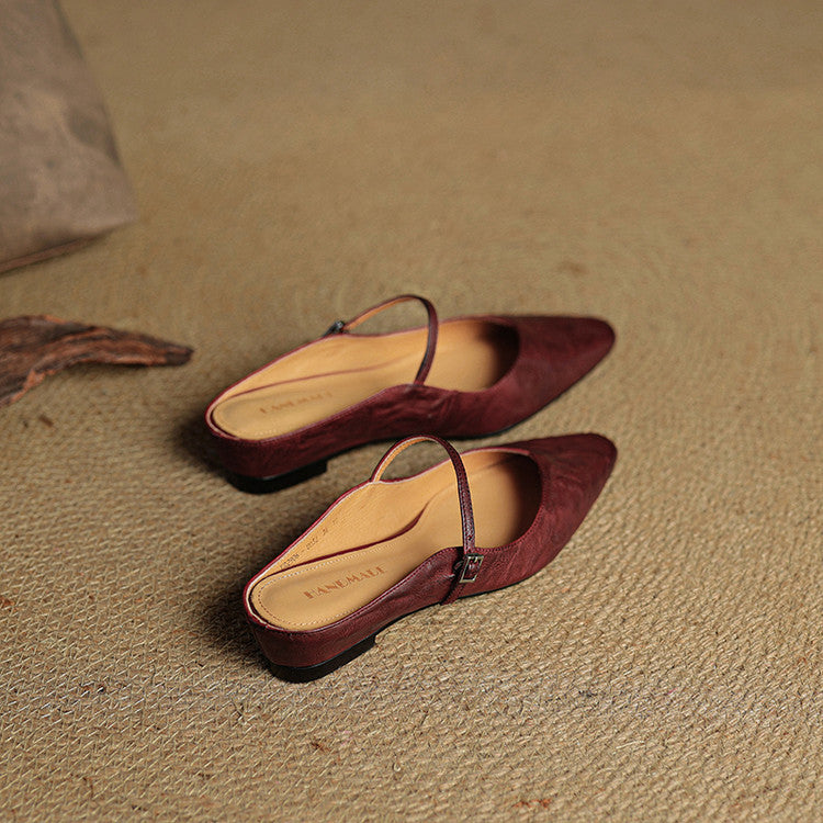 Nude women's pointed toe mule flats, versatile slip-on with a delicate strap.