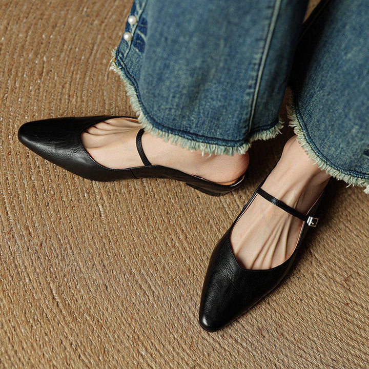 Sleek women's pointed toe flats, black, slip-on mule design with a single strap.