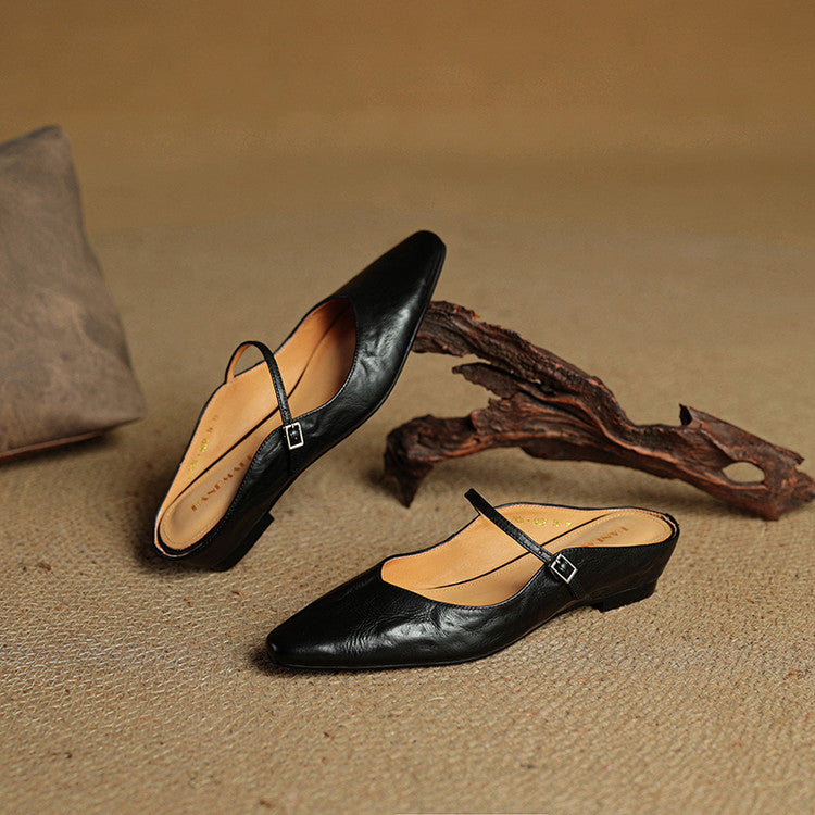Dress shoes: women's black pointed toe slip-on mule flats with an elegant strap.