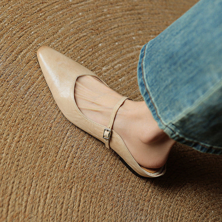 Casual yet sophisticated women's pointed toe slip-on mules, strap accent.