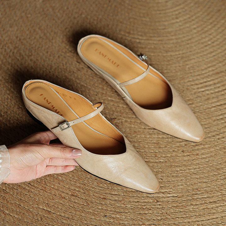 Faux leather pointed toe women's mules, classic slip-on style with strap detail.
