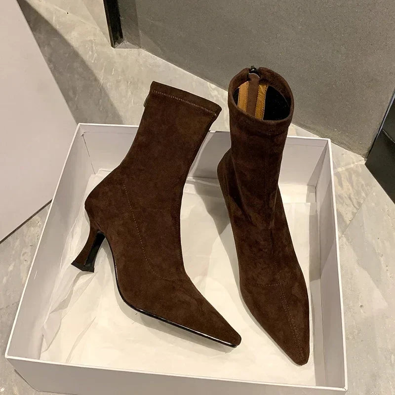 Sleek women's sock boots featuring a comfortable kitten heel & pointed toe. Elegant ankle boots for versatile style.