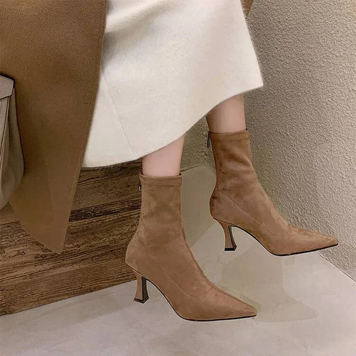Form-fitting women's sock boots, pointed toe, and kitten heel. Comfortable pull-on ankle boots with chic design.