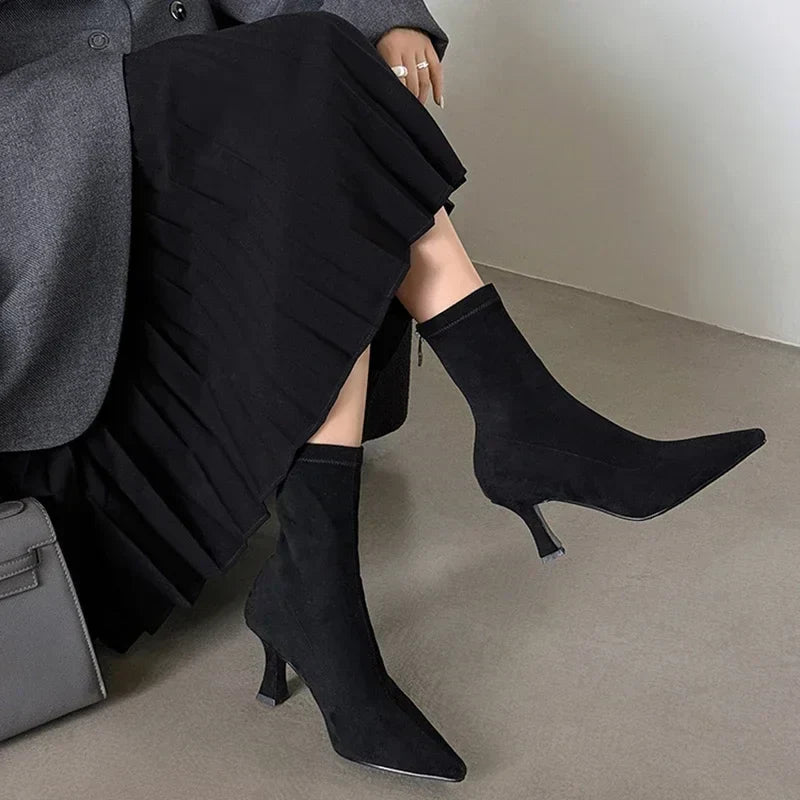 Stylish women's black sock boots with a sharp pointed toe & comfortable kitten heel. Versatile pull-on ankle footwear.