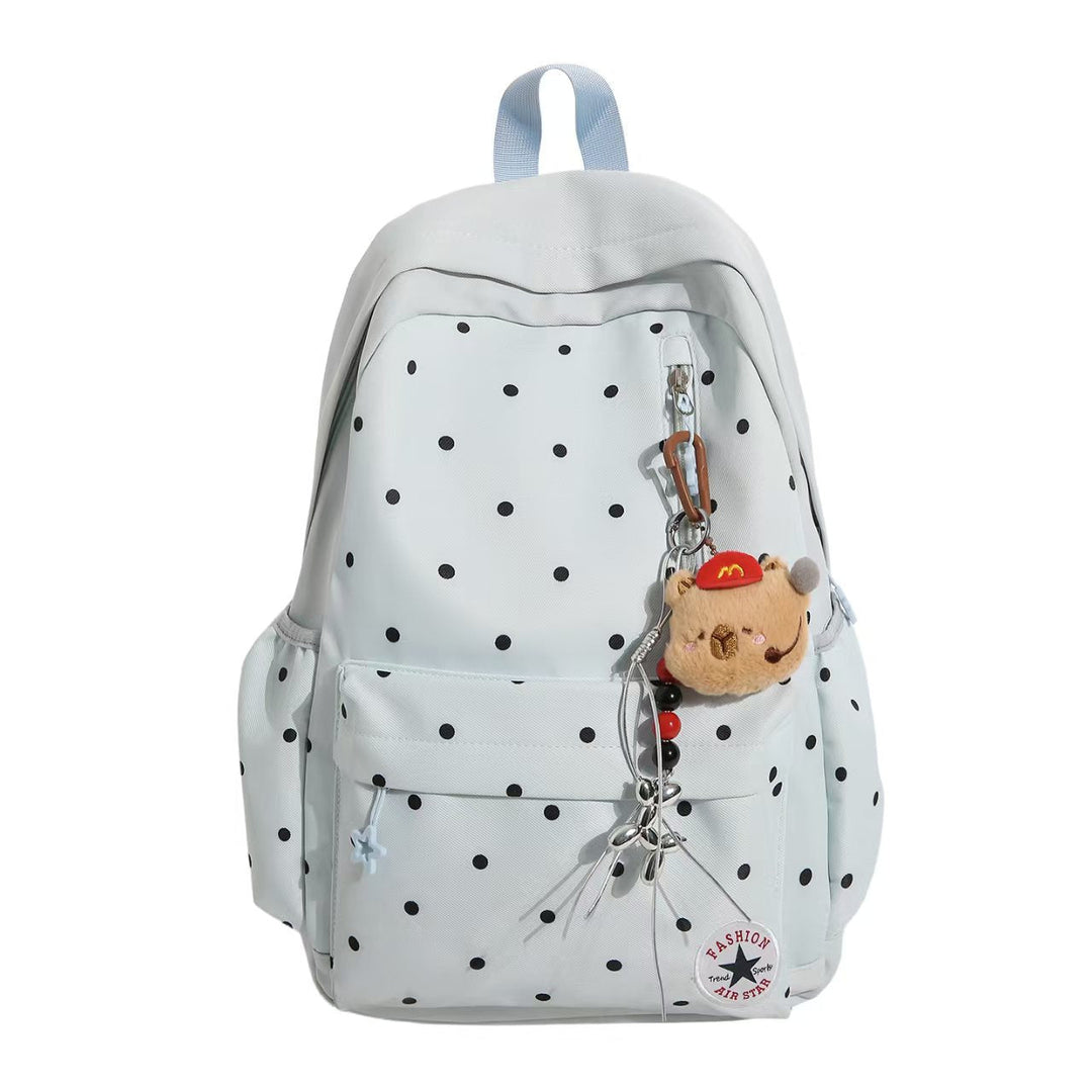 Cute black and white polka dot women's backpack, featuring elegant embellishments and a charming pendant.