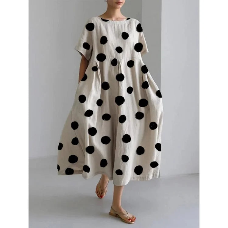 Women's polka dot maxi dress with boat neck & short sleeves, perfect for casual summer wear or vacation. Flowy style.