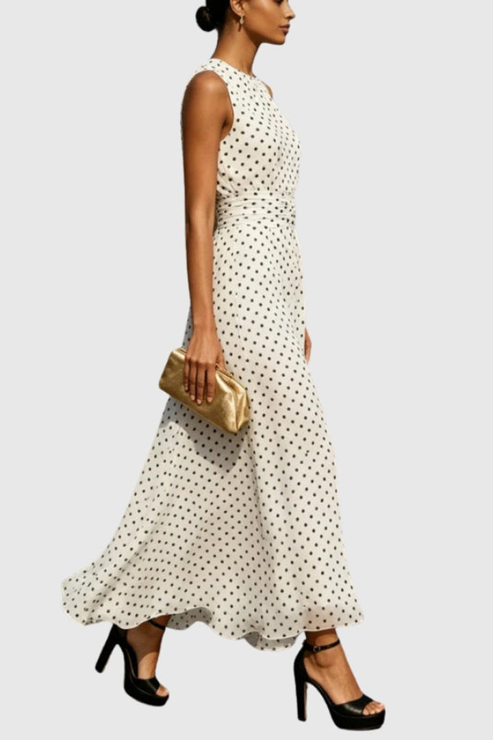 Sleeveless polka dot maxi evening gown for women, featuring a stylish ruffle hem. Perfect occasion dress.