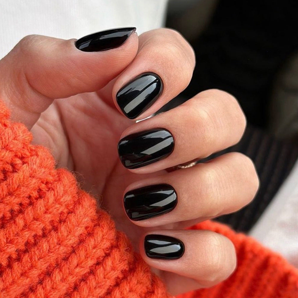 Elegant women's black glossy press-on nails. Instant artificial manicure for a chic & sophisticated look.