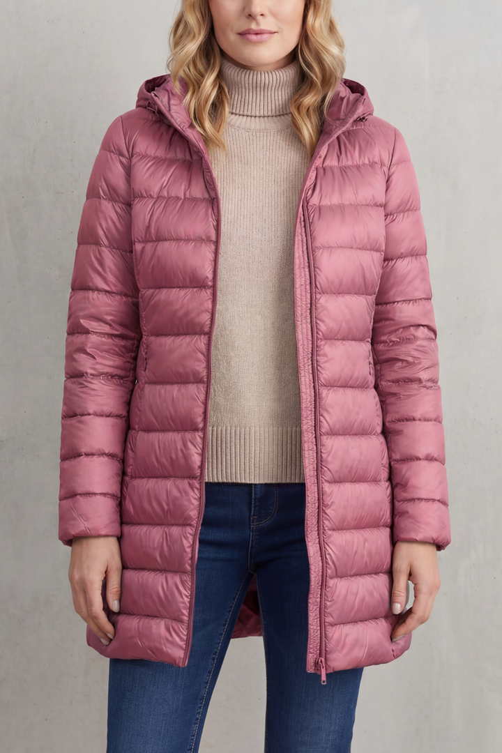 Modern women's hooded puffer. Lightweight design, ultra-warm insulation, and packable for sleek winter fashion.