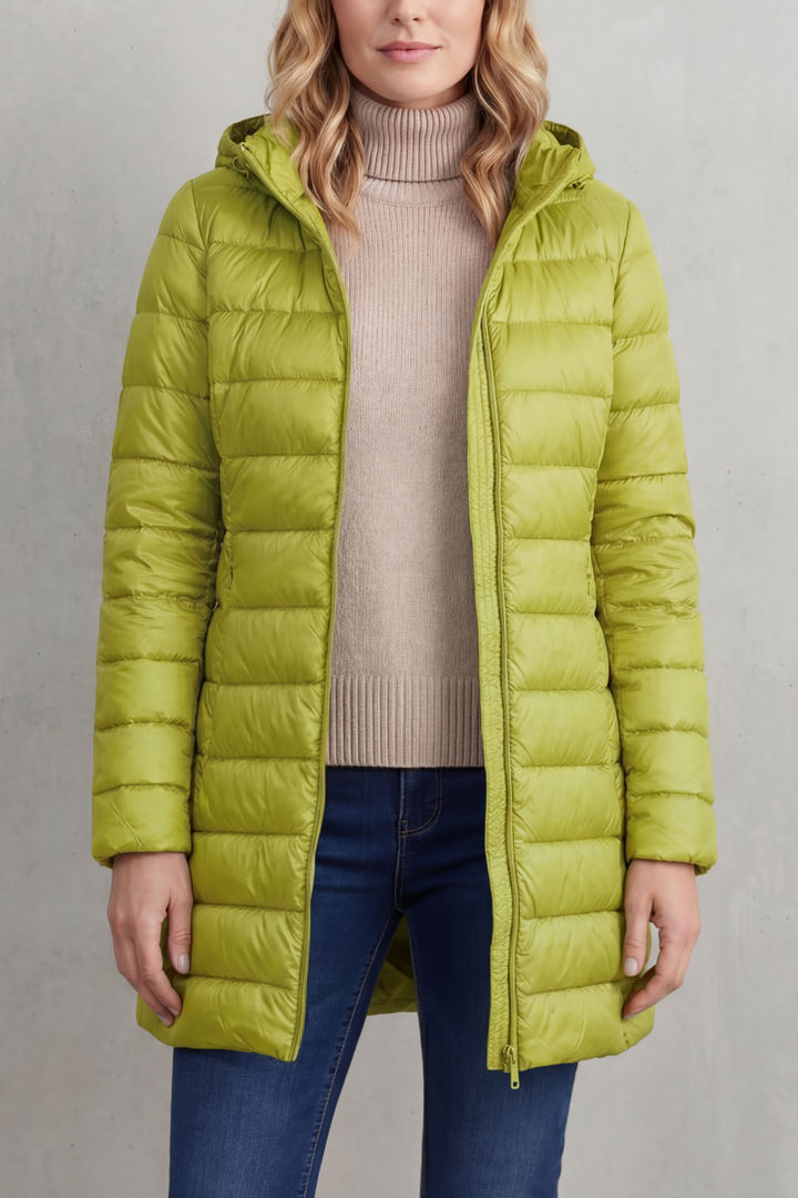 Woman wearing a stylish, lightweight hooded puffer jacket. Ultra-warm & packable for comfortable winter fashion.