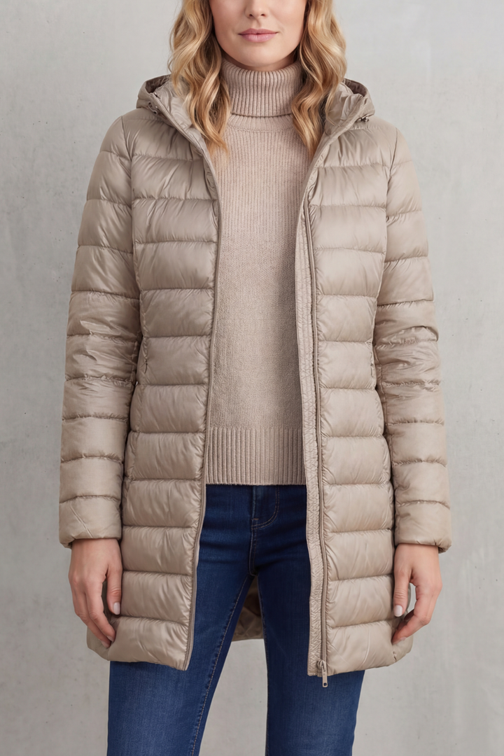 Premium women's lightweight hooded puffer. Designed for warmth, comfort, and easy packing for cold weather.