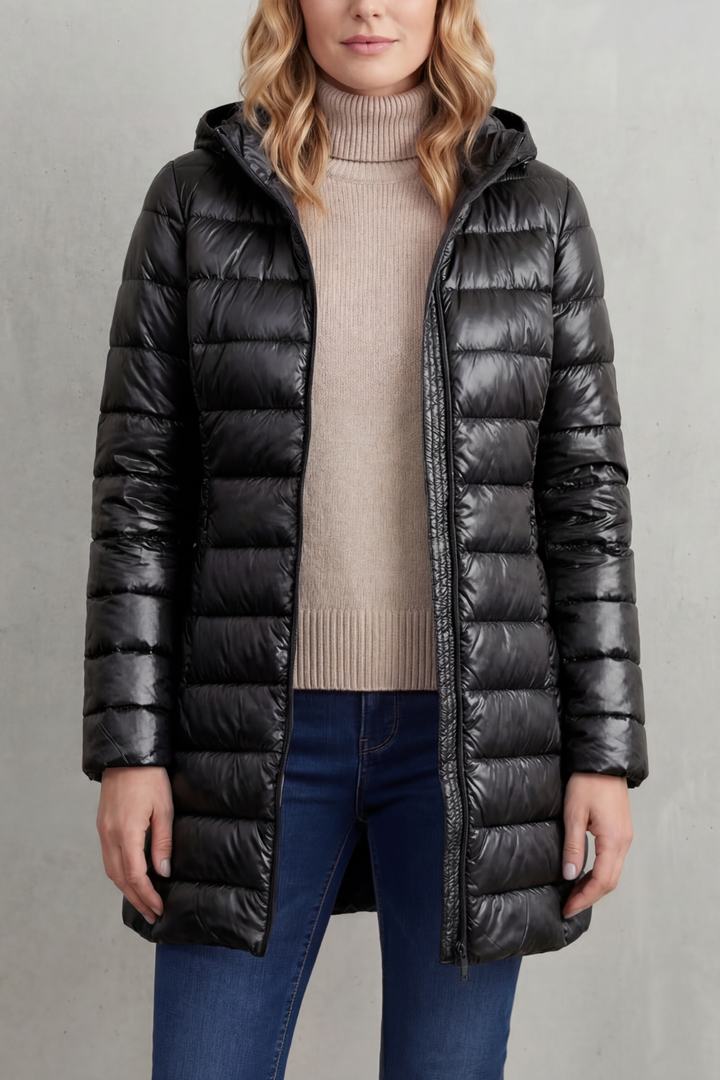 Versatile women's hooded puffer. Lightweight, packable, ultra-warm jacket for travel, casual wear, or winter sports.