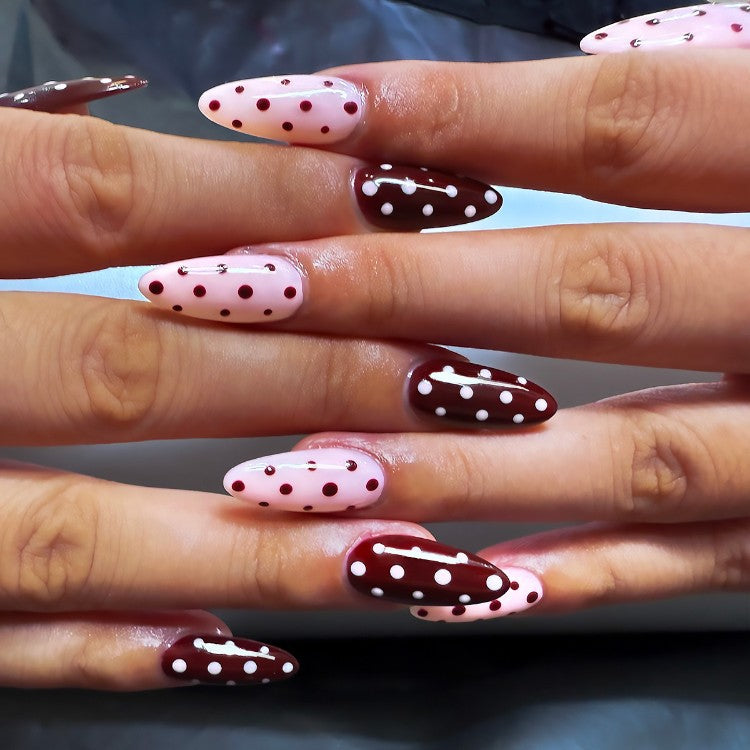 Women's press-on decorative nail tips with white polka dots on a clear base, easy application false nails.