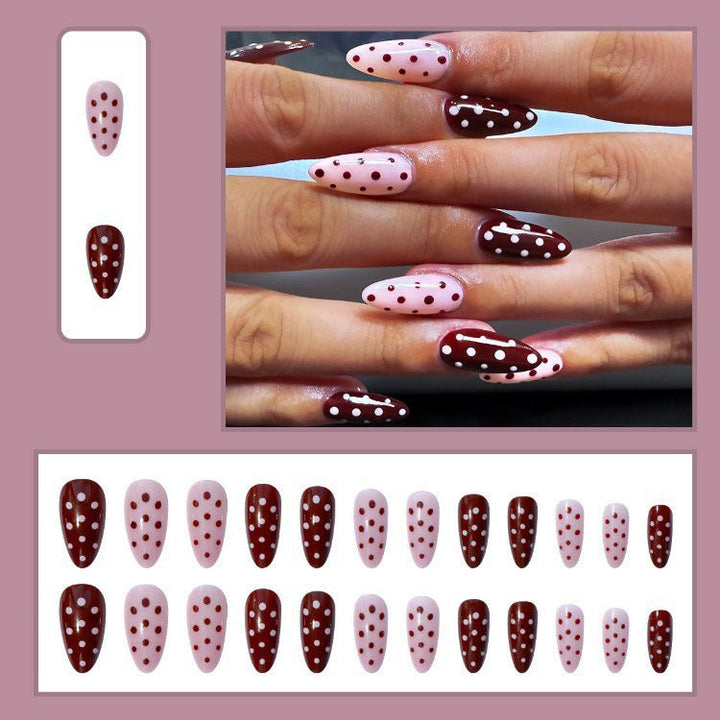 Elegant women's press-on nail tips, polka dot design, for quick and stylish fake nail art manicure.