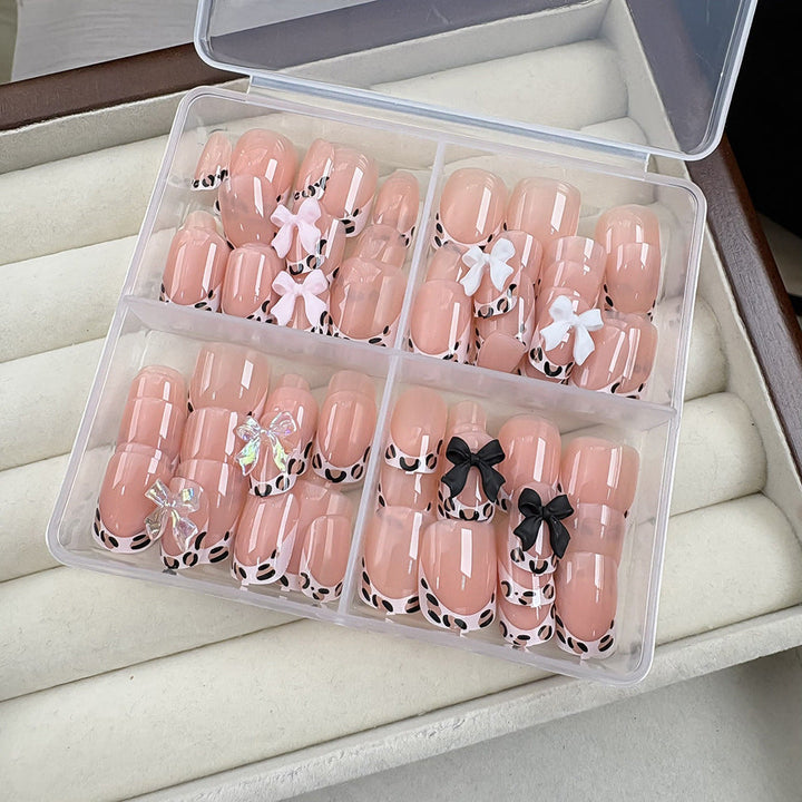 Reusable artificial nails for women, featuring elegant bow details and simple press-on application.