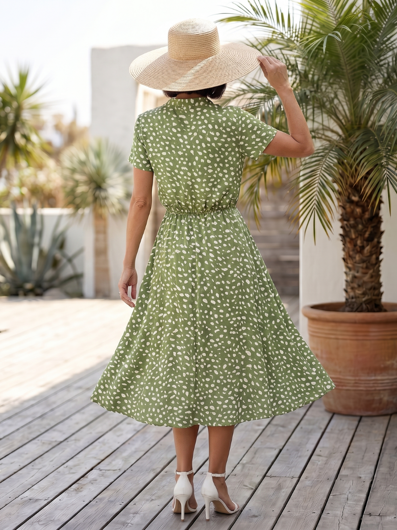Elegant printed button-front midi dress, belted for a flattering fit. Perfect for summer fashion.