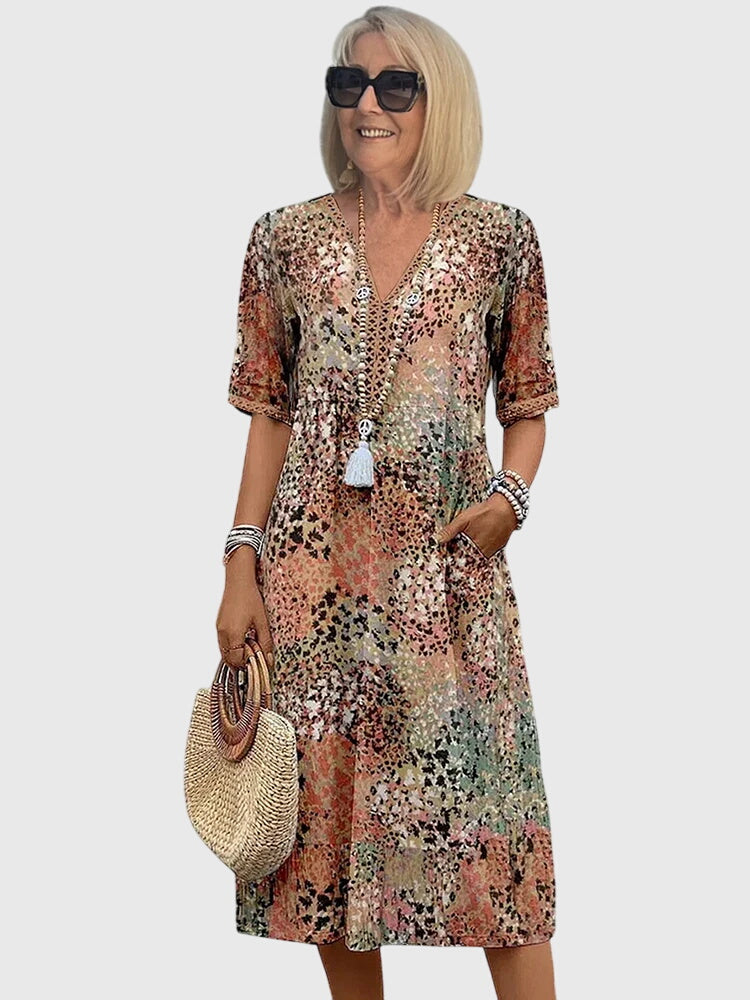 Women's printed V-neck midi dress, perfect for summer. Effortless casual day wear with a flowy design.